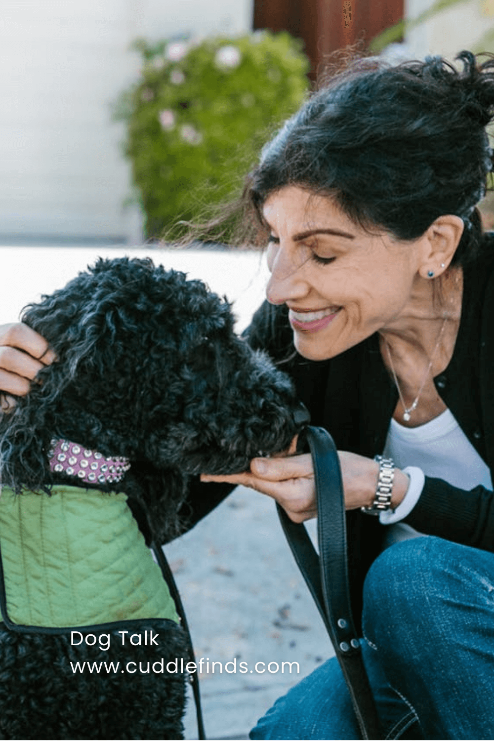 Happy Woman Holding a Black Water Dog