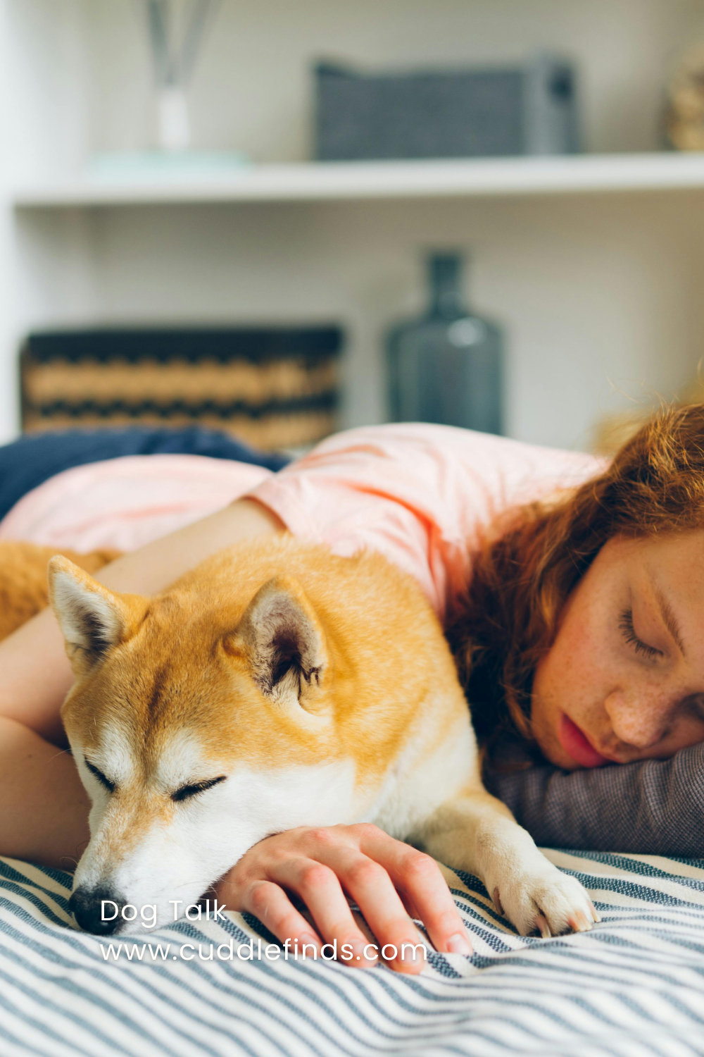 A female dog owner sleeps on her bed with her furry friend.